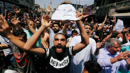 Protesters chant slogans during a protest against the new income tax law and high fuel prices, in Amman